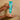 Moroccanoil Fragrance Originale Hand Cream being squeezed from a turquoise tube into an open palm.